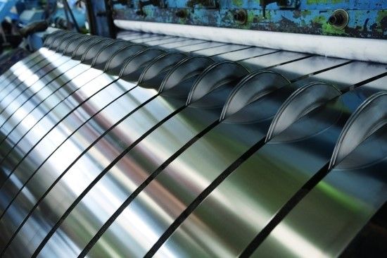 Precision slitting line cutting stainless steel coils into strips at Nivesha Alloys 100,000 sq ft facility in Ahmedabad